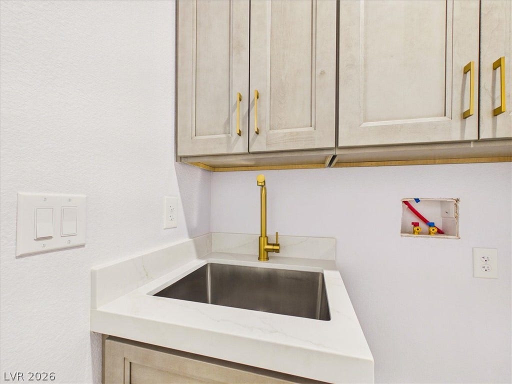 6680 S Raintree Court, Pahrump, NV 89061 Ample cabinetry and a dedicated utility sink provide exceptional functionality for everyday tasks.