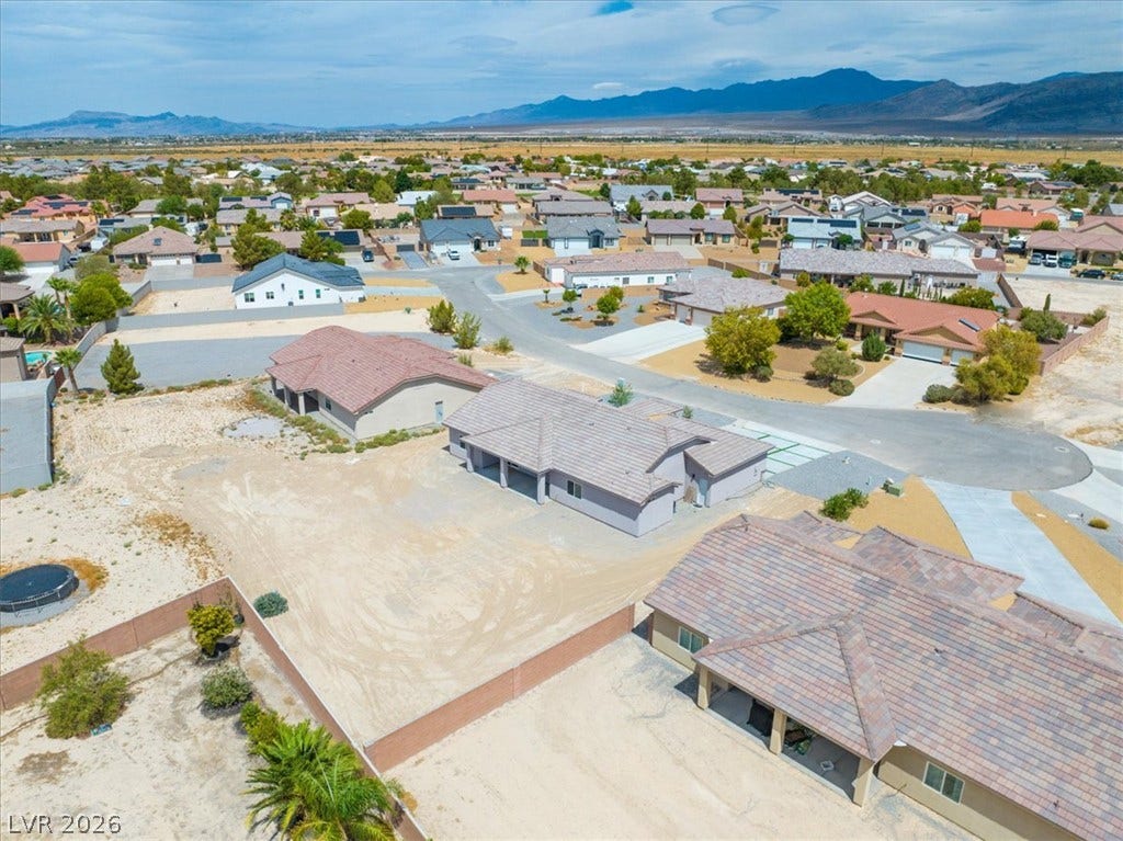 6680 S Raintree Court, Pahrump, NV 89061 An aerial perspective captures the sprawling residential neighborhood backed by mountain ridges.