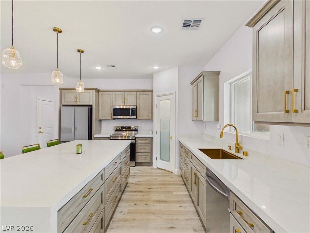 6680 S Raintree Court, Pahrump, NV 89061 Gleaming stone countertops and a spacious island anchor this updated culinary space.
