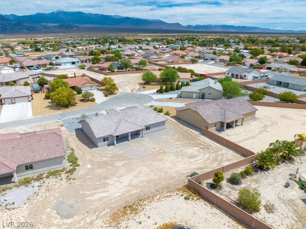 6680 S Raintree Court, Pahrump, NV 89061 Distant mountains frame this residential neighborhood of single-family homes nestled on generous desert lots.