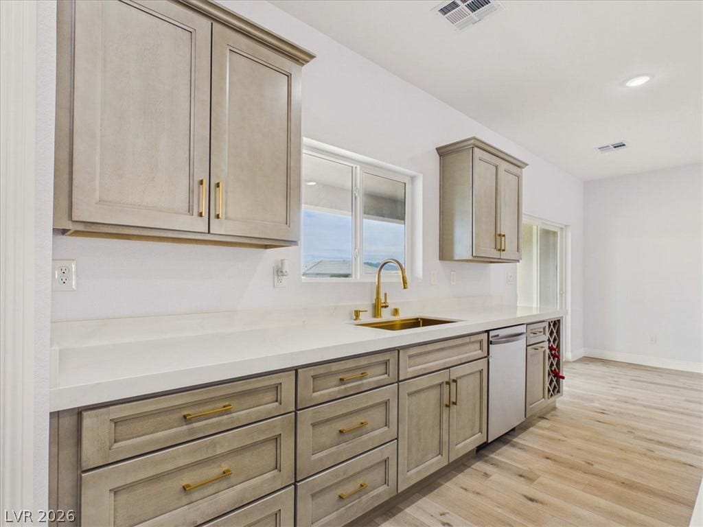 6680 S Raintree Court, Pahrump, NV 89061 Elegant cabinetry and stone countertops anchor this bright, modern kitchen space.