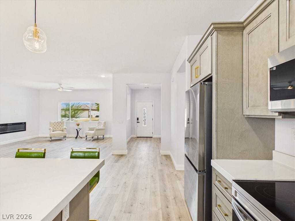 6680 S Raintree Court, Pahrump, NV 89061 An airy open layout connects the modern kitchen with light-filled living spaces.