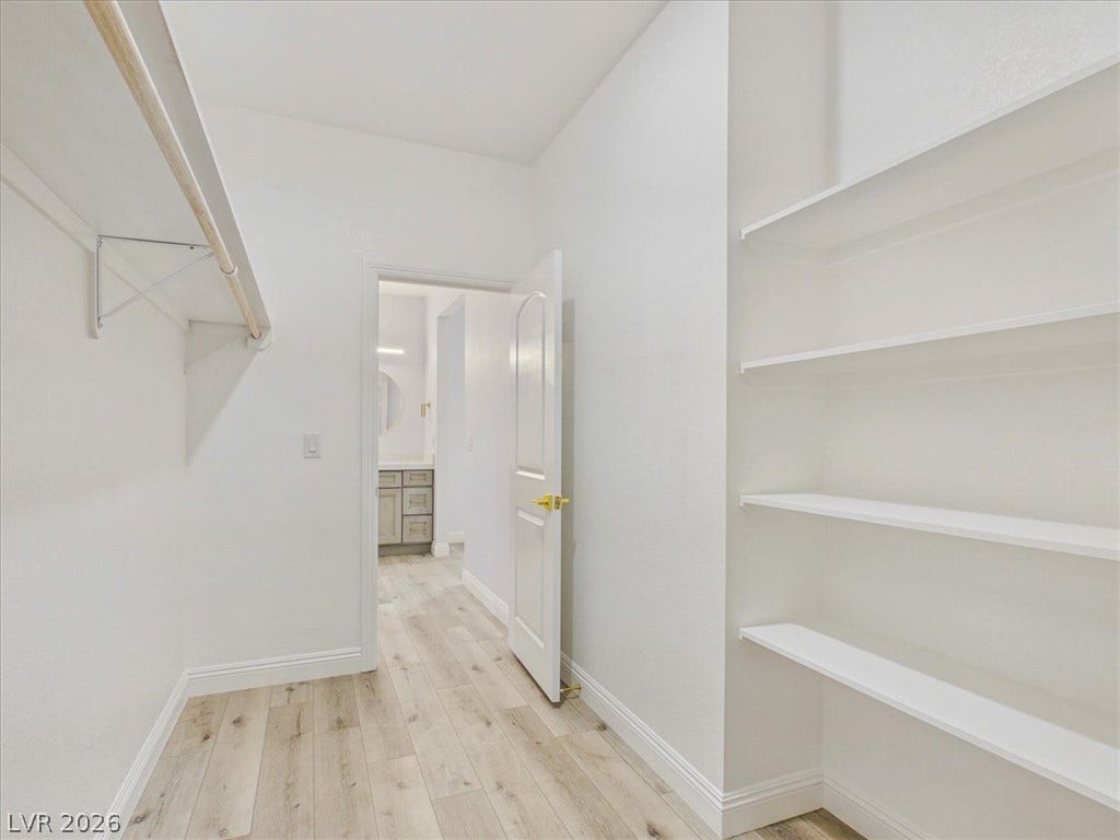6680 S Raintree Court, Pahrump, NV 89061 Ample built-in shelving and custom hanging rods maximize storage in this walk-in closet.