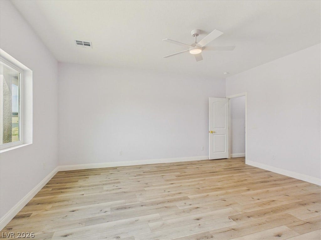 6680 S Raintree Court, Pahrump, NV 89061 Rich wood-inspired floors and clean baseboards define this versatile space.
