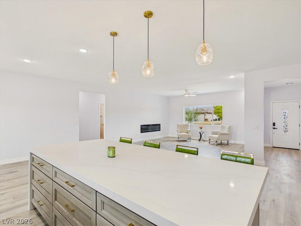 6680 S Raintree Court, Pahrump, NV 89061 Clean lines and smooth flooring define this light-filled, open-concept living area.