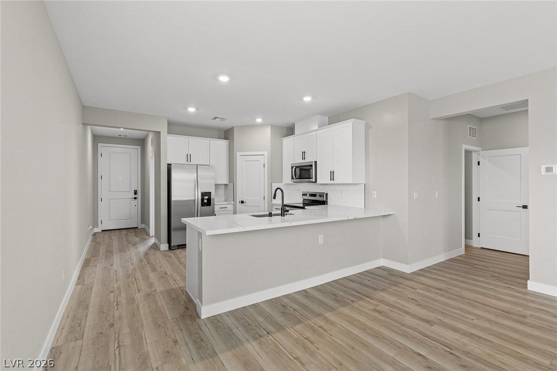 4608 Cave Lake Avenue, North Las Vegas, NV 89032 Recessed lighting illuminates this modern kitchen with seamless transitions to the surrounding living spaces.