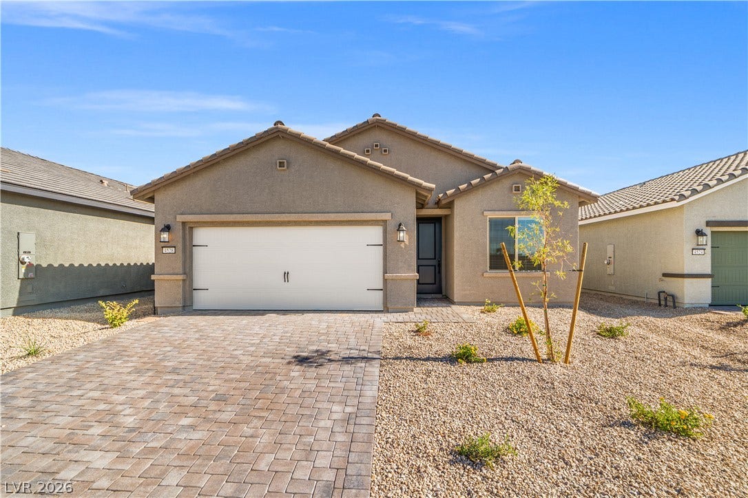 4608 Cave Lake Avenue, North Las Vegas, NV 89032 An inviting stone paver driveway leads to a modern single-story stucco home.