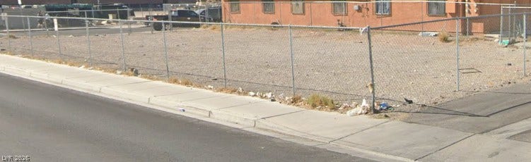 100 W Chicago Avenue, Las Vegas, NV 89102 Chain-link fencing secures this level development lot bordered by paved sidewalks.