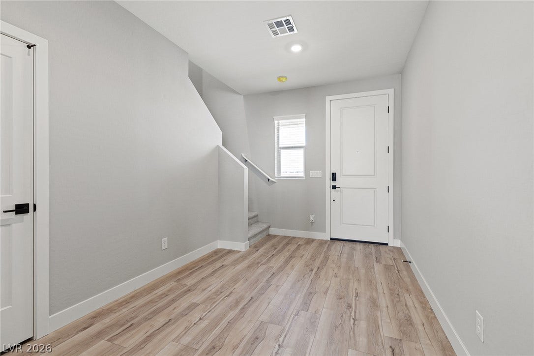 3257 Basin Desert Street, North Las Vegas, NV 89032 Smooth wood floors and crisp white trim define this clean entryway space.