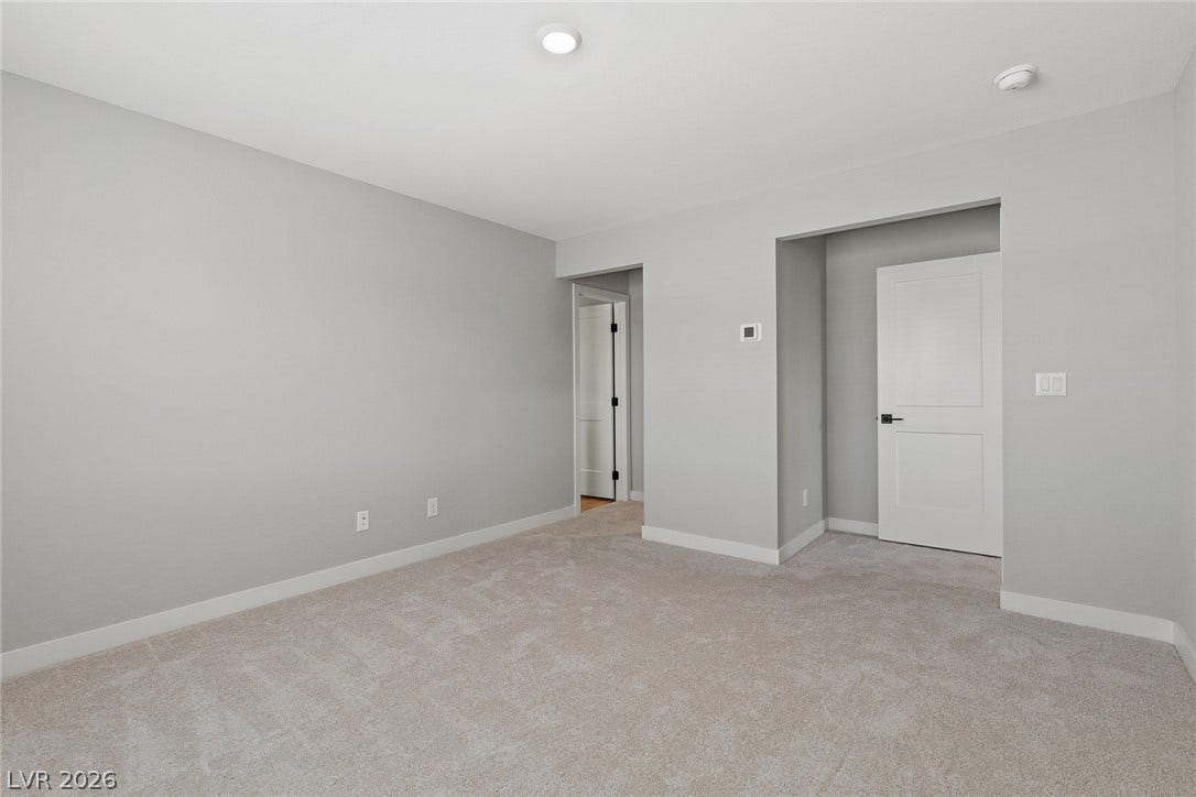 3257 Basin Desert Street, North Las Vegas, NV 89032 Plush wall-to-wall carpeting and clean architectural lines define this versatile bedroom.