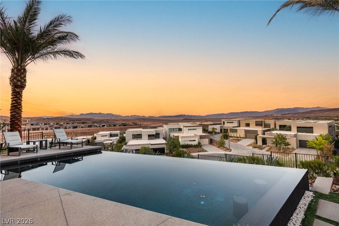 Infinity pool with sunset views, offering a captivating backdrop for desert living.