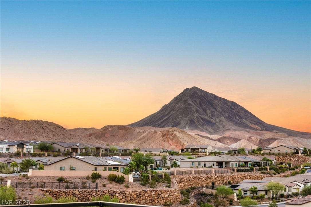 Witness an expansive desert panorama with mountain backdrop, offering serene living in this residential community.