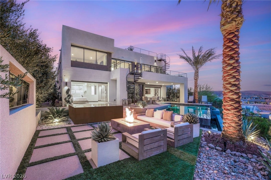 An inviting outdoor oasis with a sparkling pool and fire pit, perfect for evening gatherings.