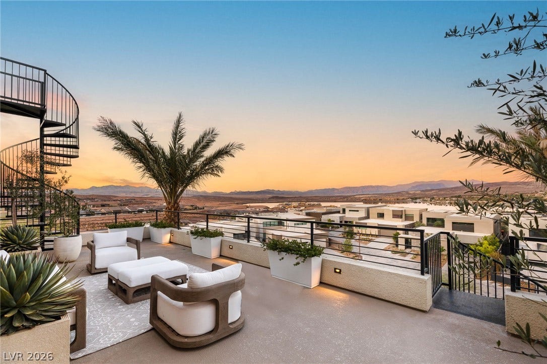 Rooftop patio with stunning mountain and city views, ideal for entertaining under the open sky.