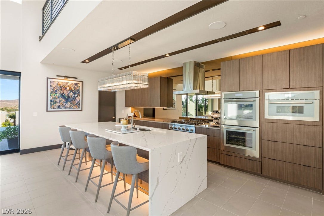 Culinary delights await in this modern kitchen with high ceilings and a substantial island.