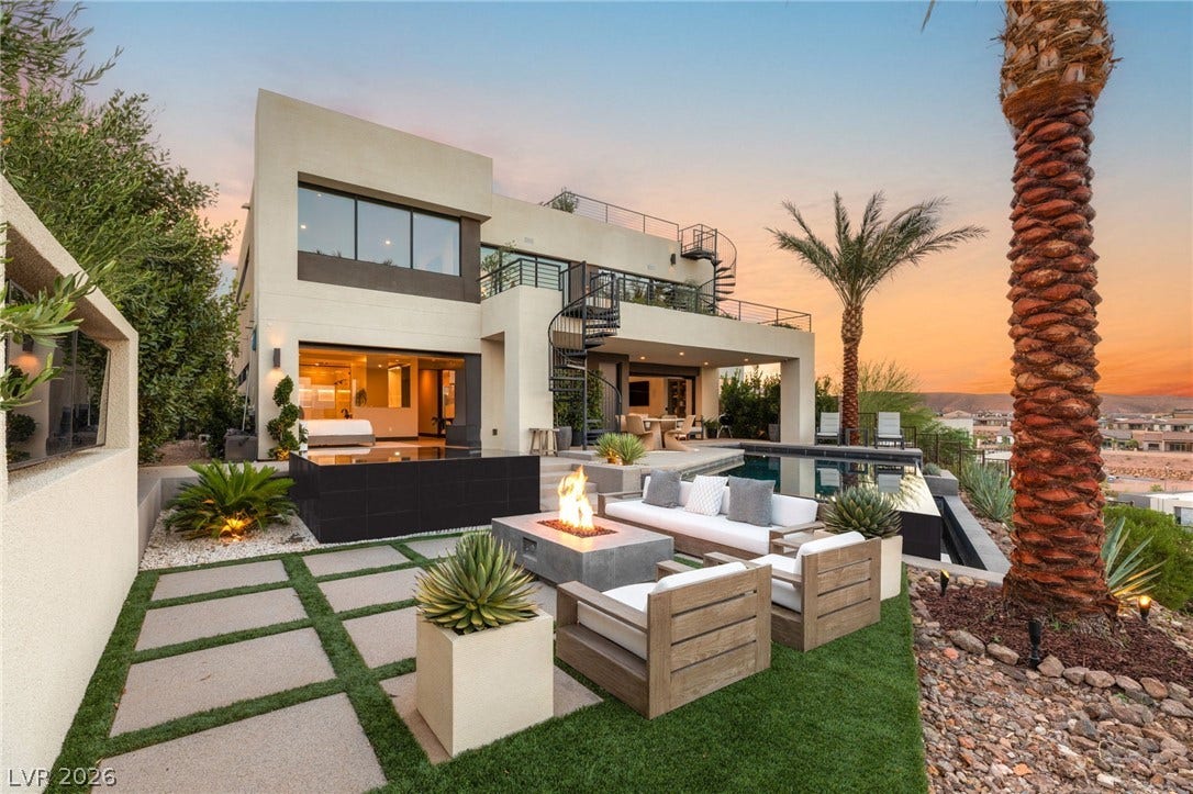 An exquisite outdoor space for entertaining, featuring a pool and a cozy fire pit.