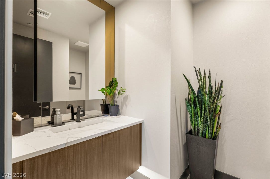 A well-appointed bathroom features an integrated sink within a modern vanity.