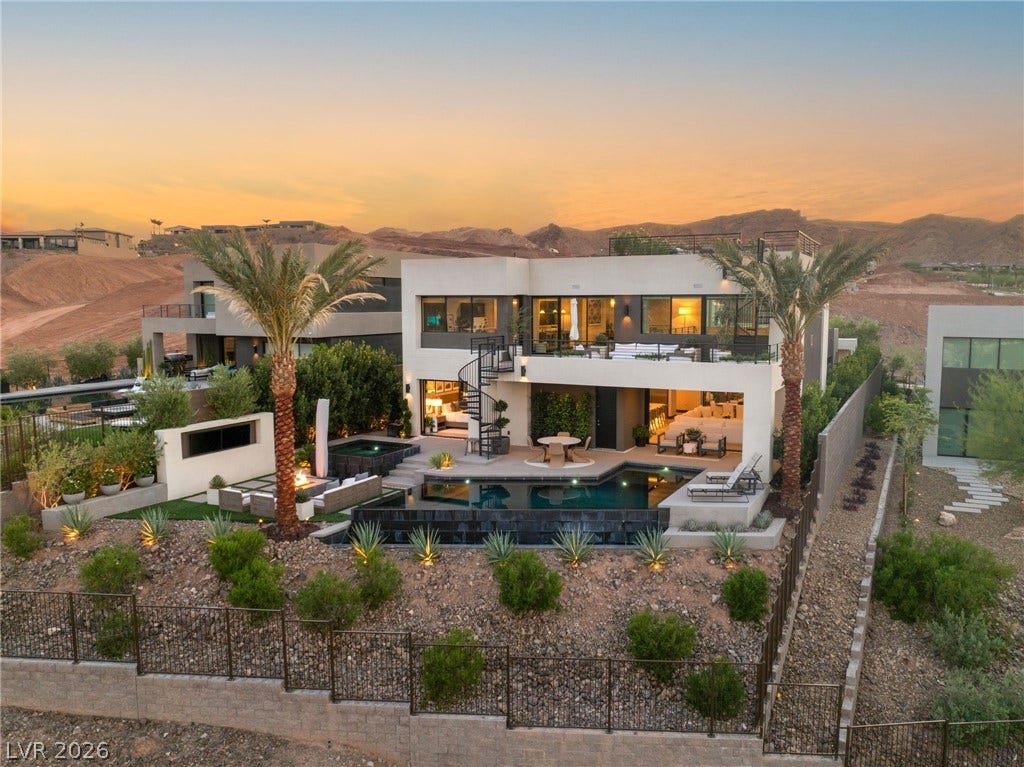 An opulent desert oasis presents expansive mountain vistas, with a private pool and fire pit for elevated living.