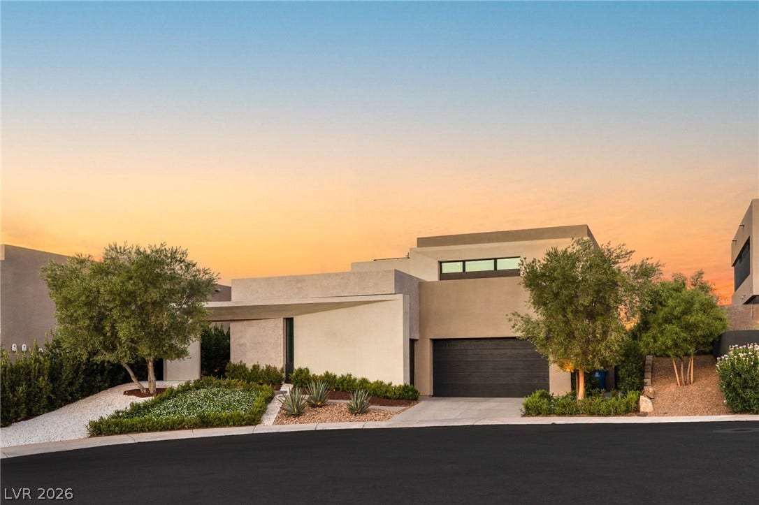 Clean lines and desert landscaping define this modern residence with an integrated garage.