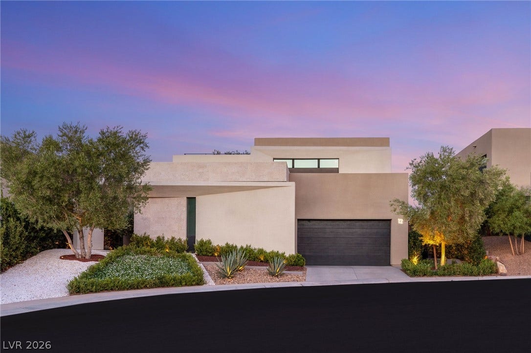 Clean lines and well-tended landscaping define this captivating modern facade at twilight.
