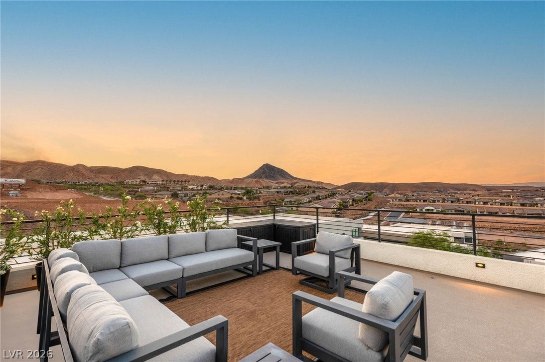 Rooftop terrace provides a sweeping vista of distant mountains and the expansive neighborhood.