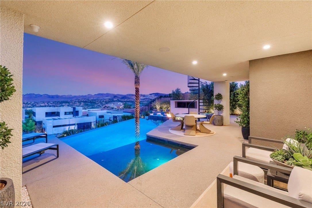 An exquisite infinity-edge pool creates a seamless horizon with distant mountains, offering a captivating private oasis.