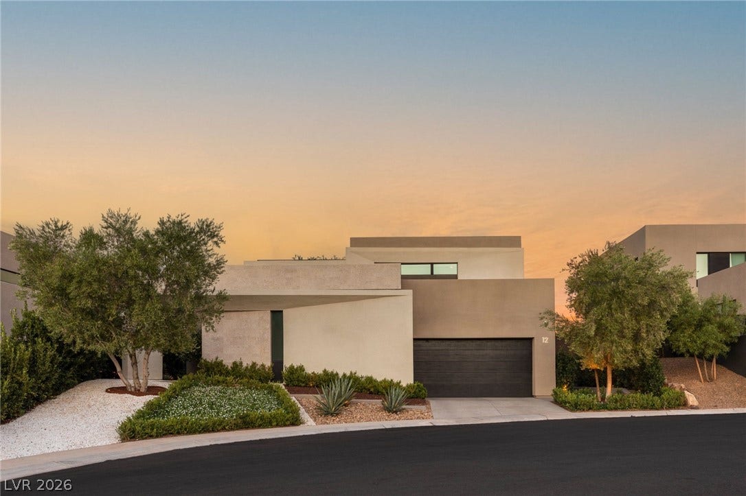 Modern desert architecture with a clean-lined facade and well-maintained xeriscape landscaping.