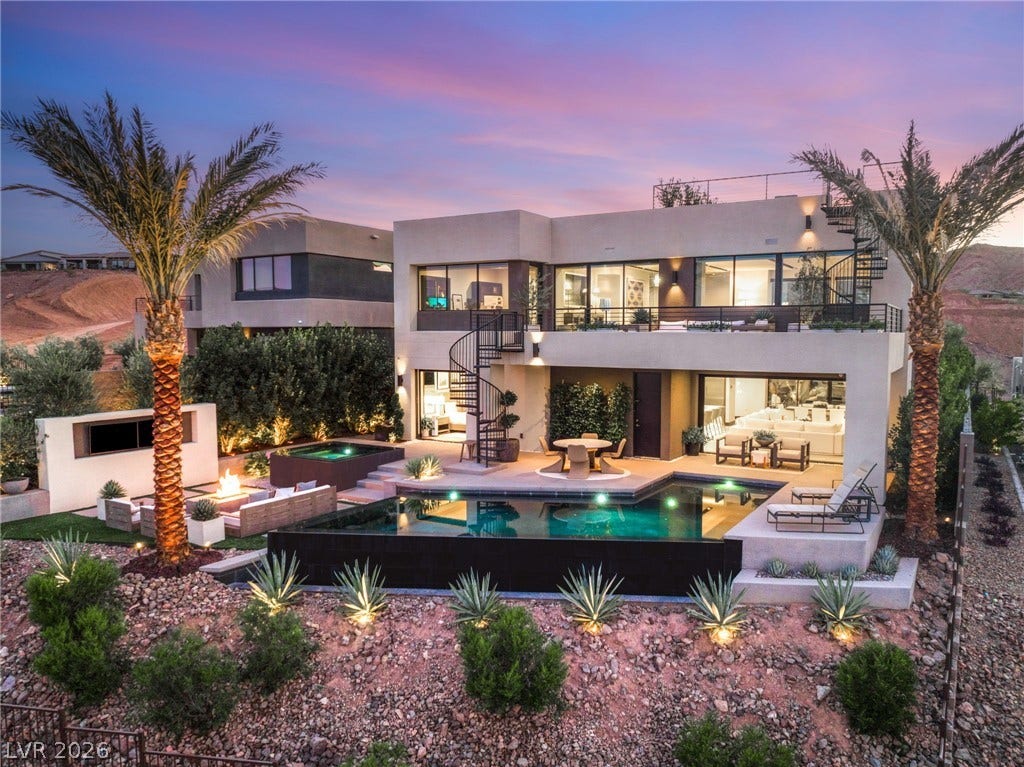 An exquisite two-story residence boasts a sprawling private pool and spa, ideal for sophisticated outdoor living.