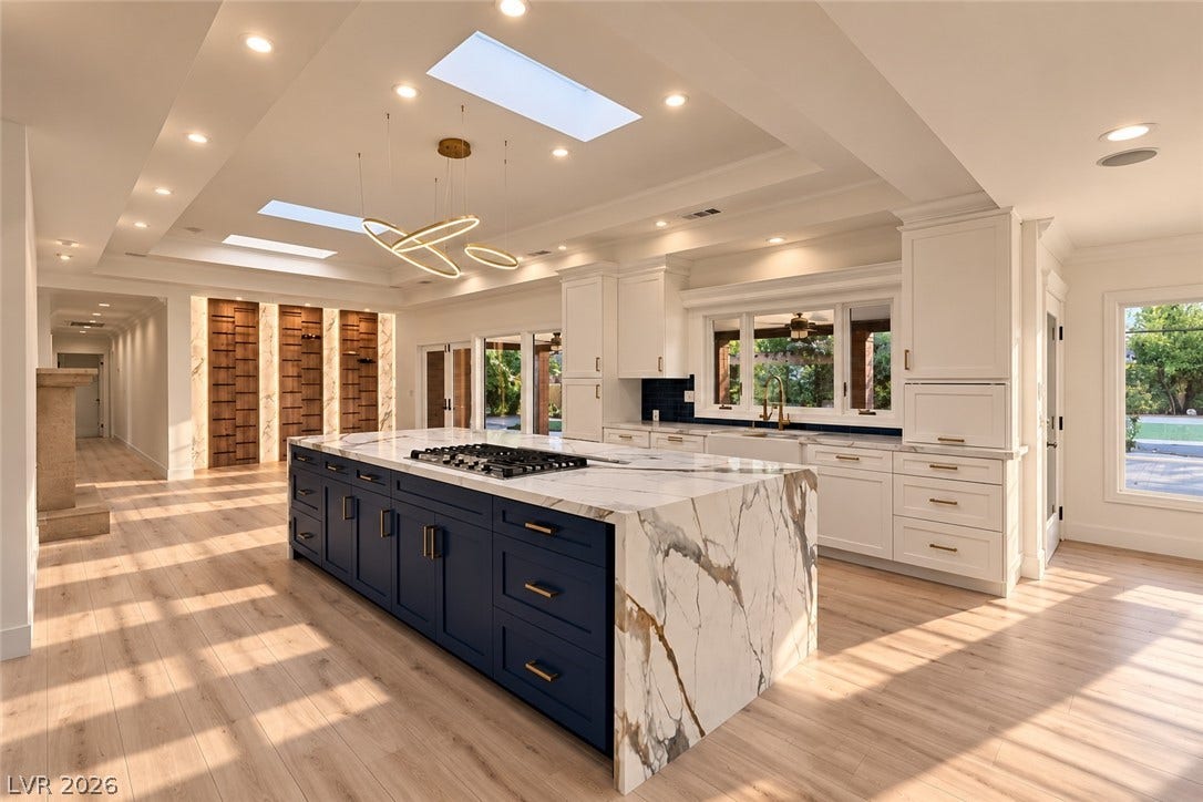 2001 Silver Avenue, Las Vegas, NV 89102 Hardwood floors and an expansive stone island anchor this modern kitchen beneath recessed lighting.