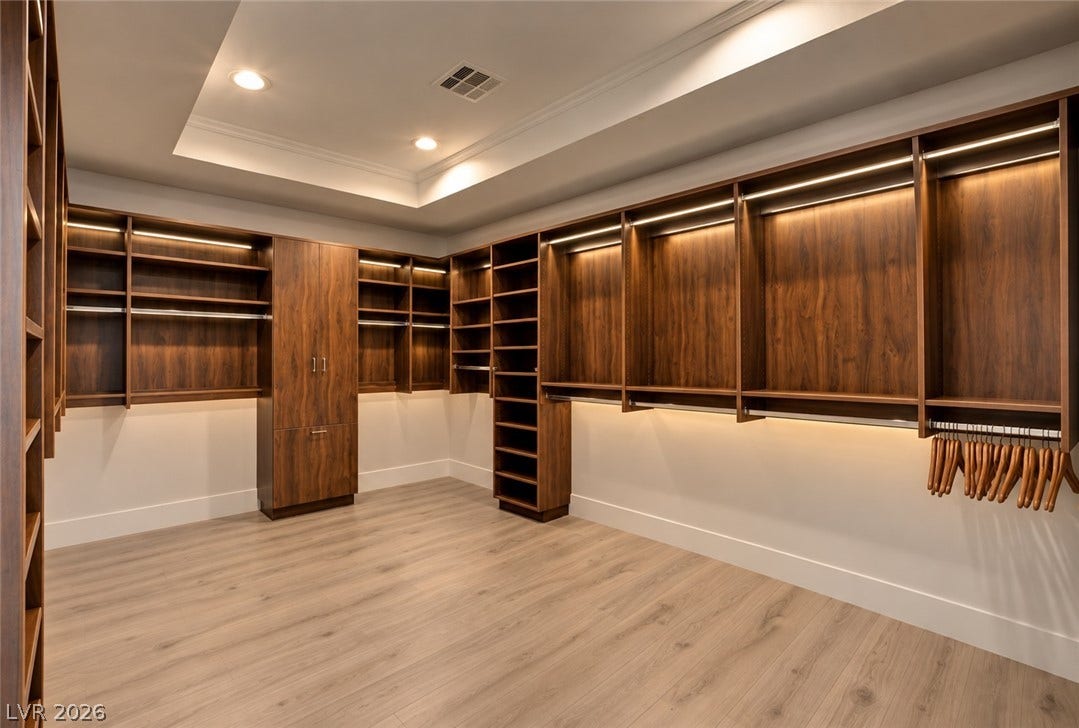 2001 Silver Avenue, Las Vegas, NV 89102 Rich wood built-ins and integrated lighting elevate this spacious dressing area.