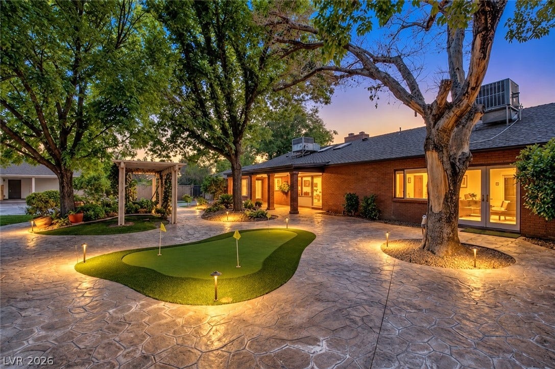 2001 Silver Avenue, Las Vegas, NV 89102 Mature trees shade a patterned stone patio featuring a private putting green.