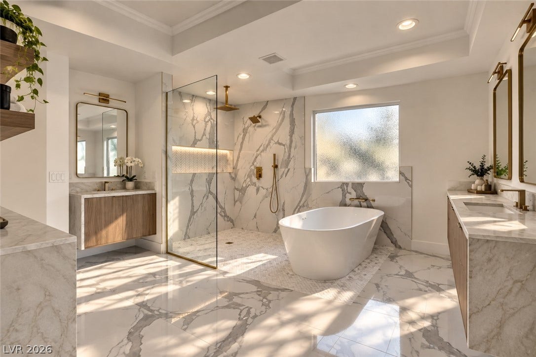 2001 Silver Avenue, Las Vegas, NV 89102 Elegant marble surfaces pair with a freestanding tub and a spacious walk-in shower.