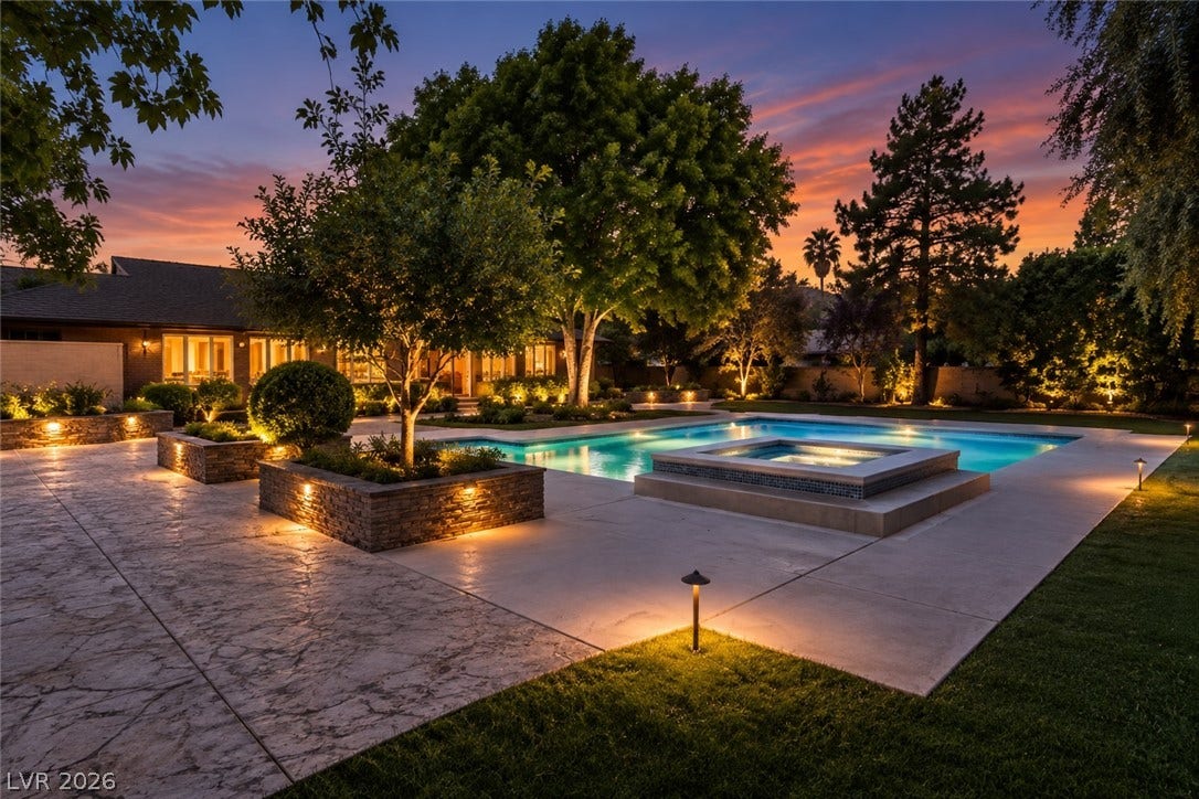 2001 Silver Avenue, Las Vegas, NV 89102 An inviting backyard oasis features a pristine swimming pool and elevated spa framed by stone masonry.