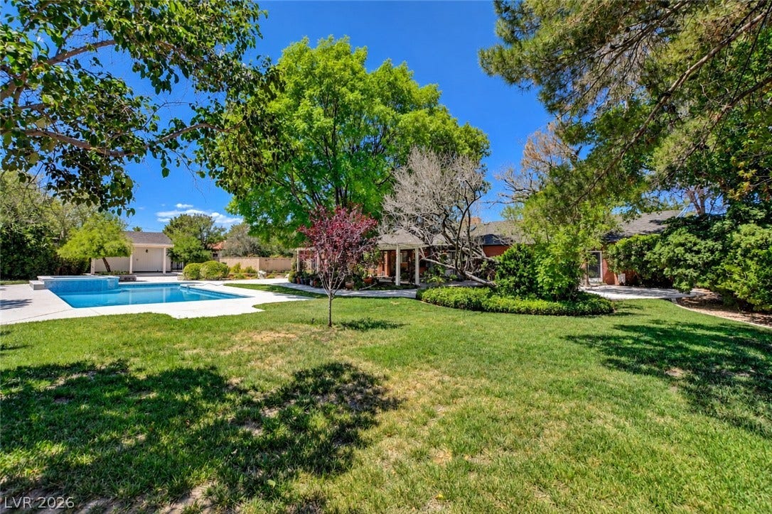 2001 Silver Avenue, Las Vegas, NV 89102 Mature trees shade a spacious green lawn bordering the refreshing in-ground pool.