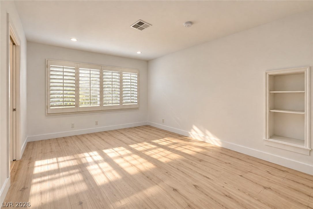 2001 Silver Avenue, Las Vegas, NV 89102 Gleaming wood floors and built-in shelving define this versatile room with classic plantation shutters.
