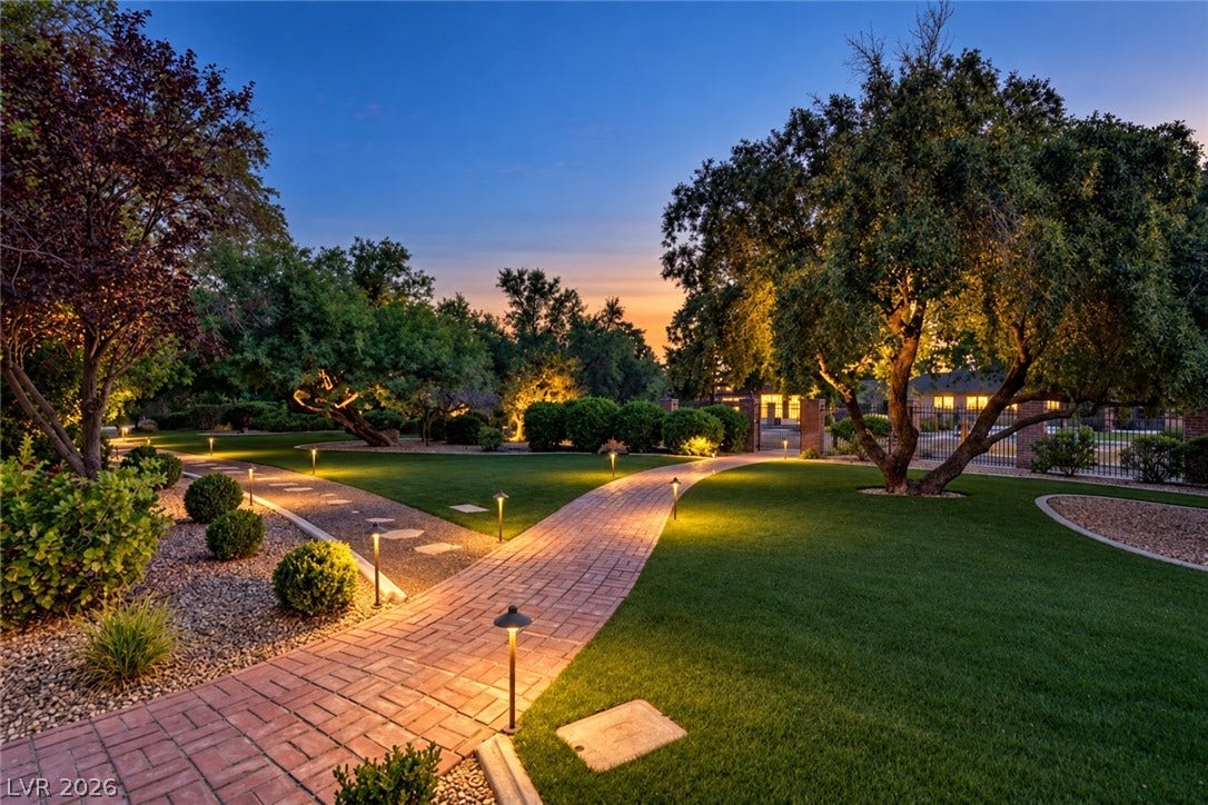2001 Silver Avenue, Las Vegas, NV 89102 Manicured lawns and illuminated brick pathways wind through mature trees and elegant landscaping.