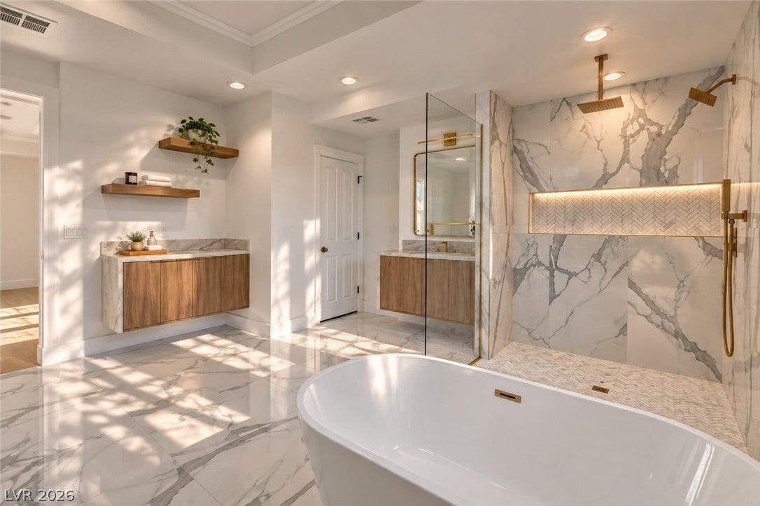 2001 Silver Avenue, Las Vegas, NV 89102 Marble tile floors and a sleek freestanding tub define this contemporary bathroom space.