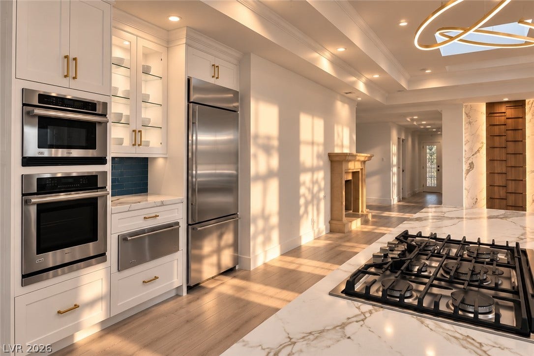 2001 Silver Avenue, Las Vegas, NV 89102 Rich marble countertops and high-end stainless steel appliances anchor this modern, light-filled kitchen space.