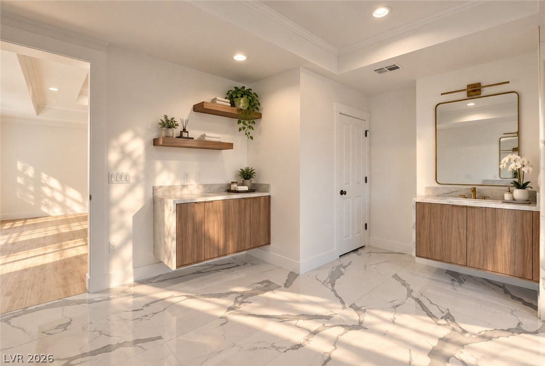 2001 Silver Avenue, Las Vegas, NV 89102 Polished stone tile flooring and modern floating vanities anchor this spacious bathroom design.