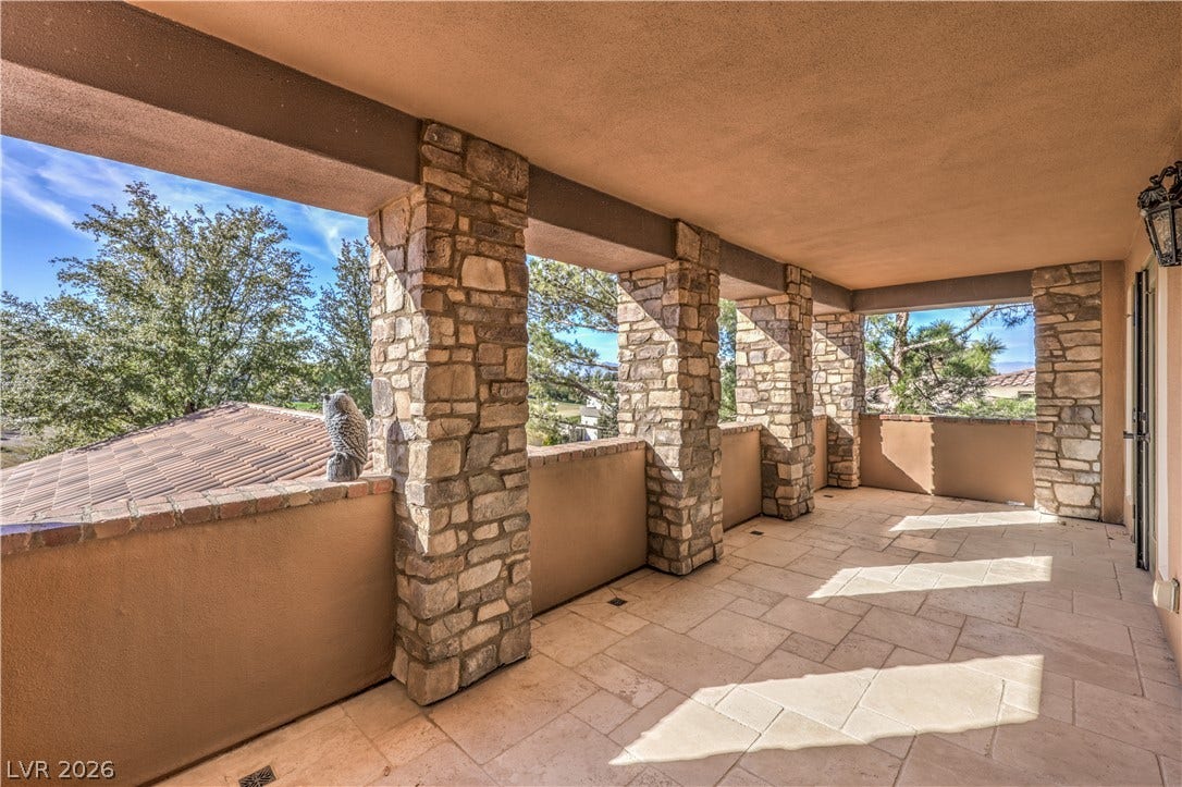16 Anthem Pointe Court, Henderson, NV 89052 Massive stone pillars frame sweeping neighborhood views from this tiled covered balcony.