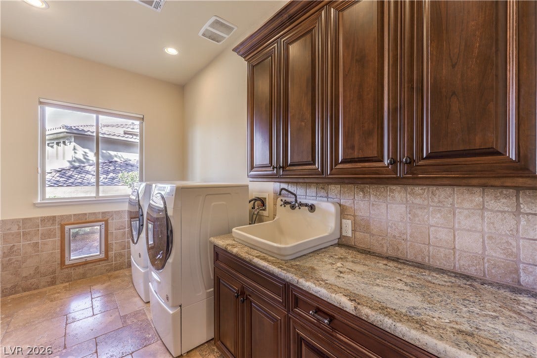 16 Anthem Pointe Court, Henderson, NV 89052 Rich wood cabinetry and stone countertops elevate this highly functional utility space.