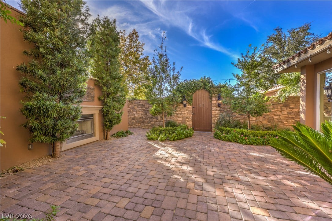 16 Anthem Pointe Court, Henderson, NV 89052 An inviting stone-paved courtyard is enclosed by privacy walls and an outdoor fireplace.