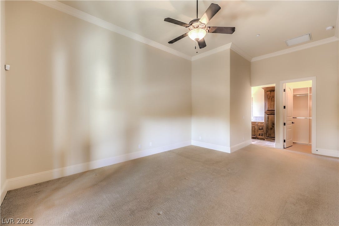 16 Anthem Pointe Court, Henderson, NV 89052 High ceilings, classic crown molding, and plush carpeting define this spacious bedroom suite.