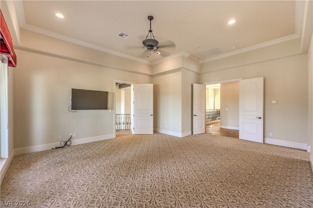 16 Anthem Pointe Court, Henderson, NV 89052 Patterned carpeting and a classic tray ceiling define this open, airy upstairs living space.