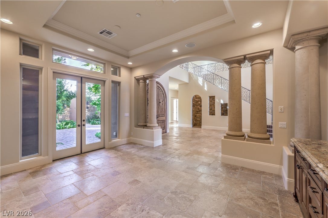 16 Anthem Pointe Court, Henderson, NV 89052 Classical columns and elegant stone tile flooring frame a grand entryway with soaring tray ceilings.