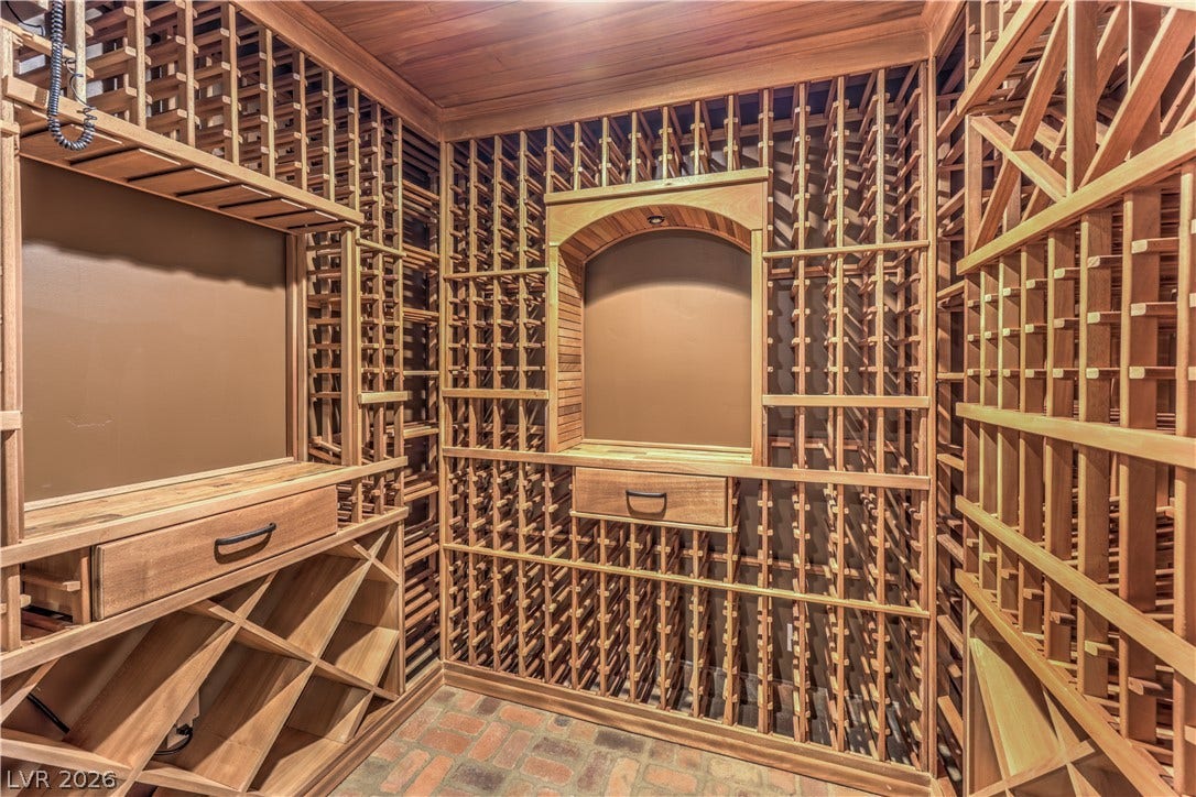 16 Anthem Pointe Court, Henderson, NV 89052 Floor-to-ceiling wooden racks and rustic brick flooring define this dedicated wine cellar.