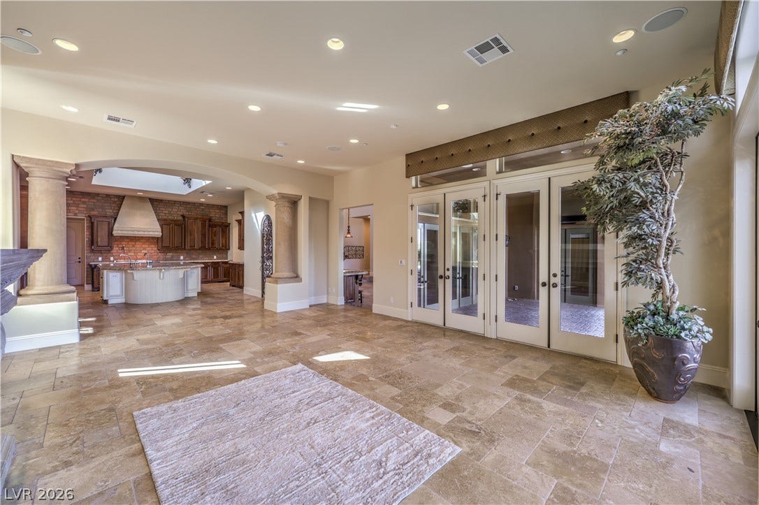 16 Anthem Pointe Court, Henderson, NV 89052 Stone tile floors and architectural columns define this elegant, open living space.