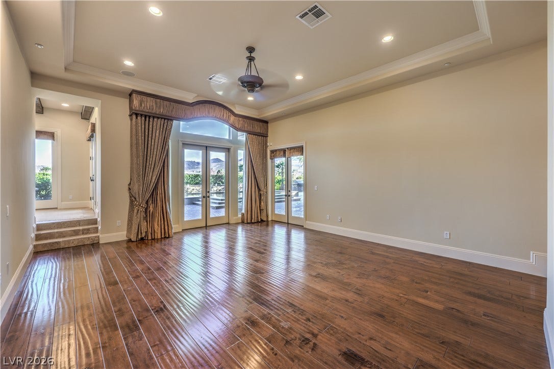 16 Anthem Pointe Court, Henderson, NV 89052 Polished wood floors and high tray ceilings elevate this elegant, light-filled living space.
