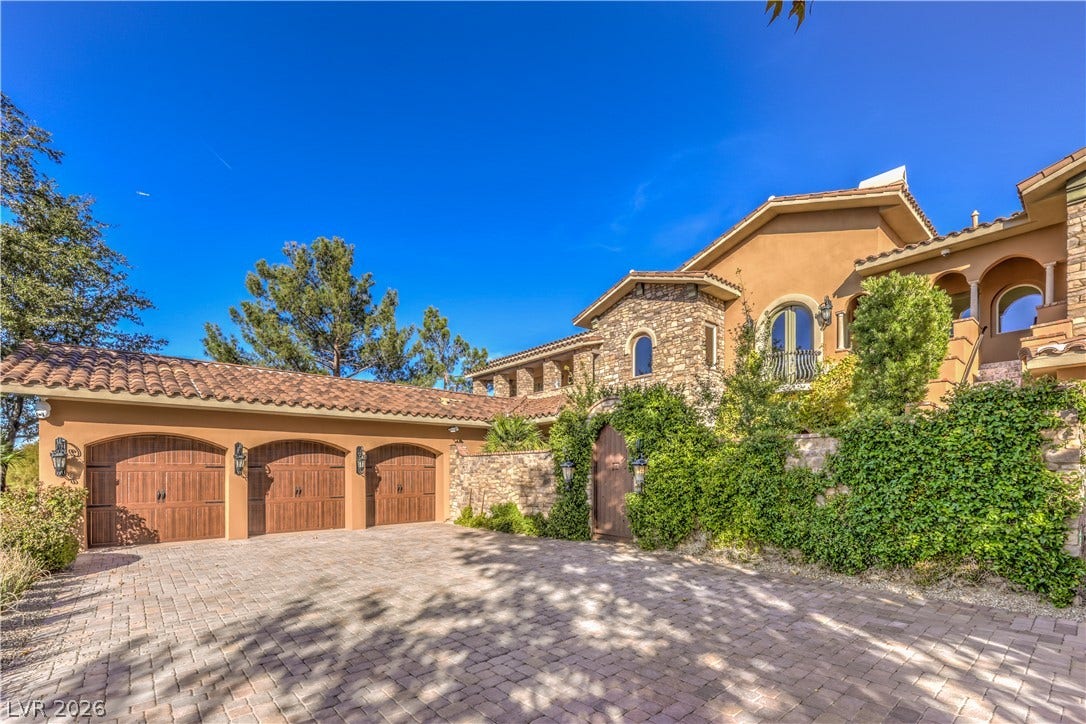 16 Anthem Pointe Court, Henderson, NV 89052 An elegant paved driveway leads to the arched garage bays and stone-accented facade.