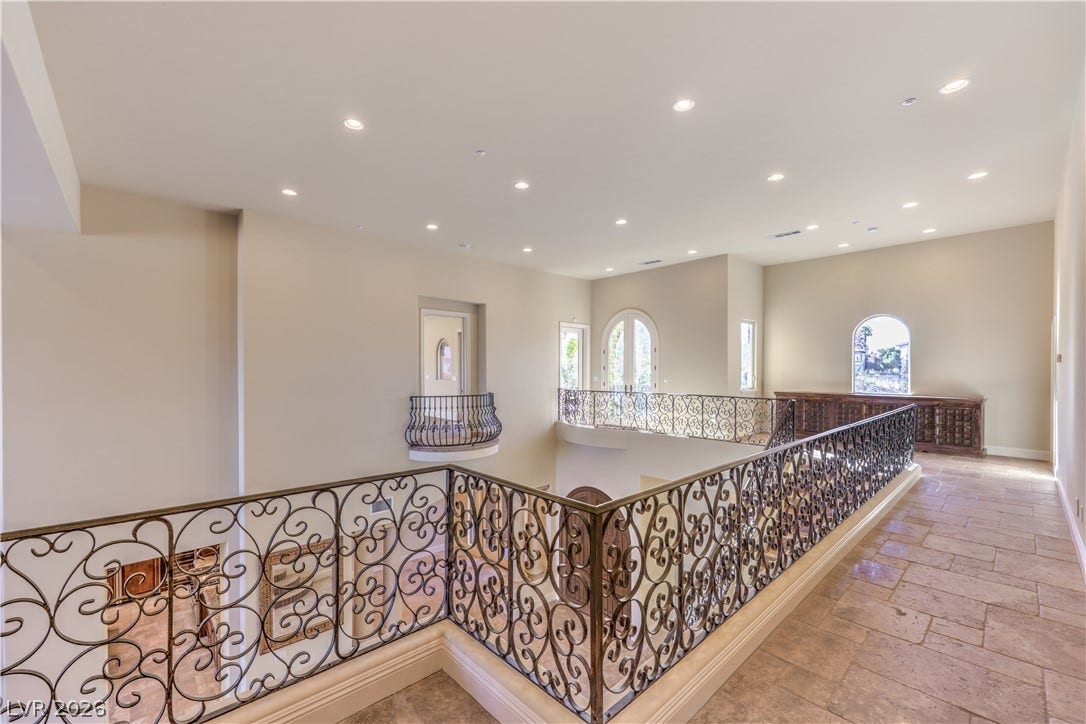 16 Anthem Pointe Court, Henderson, NV 89052 Ornate wrought iron railings line this elevated hallway overlooking the lower level.